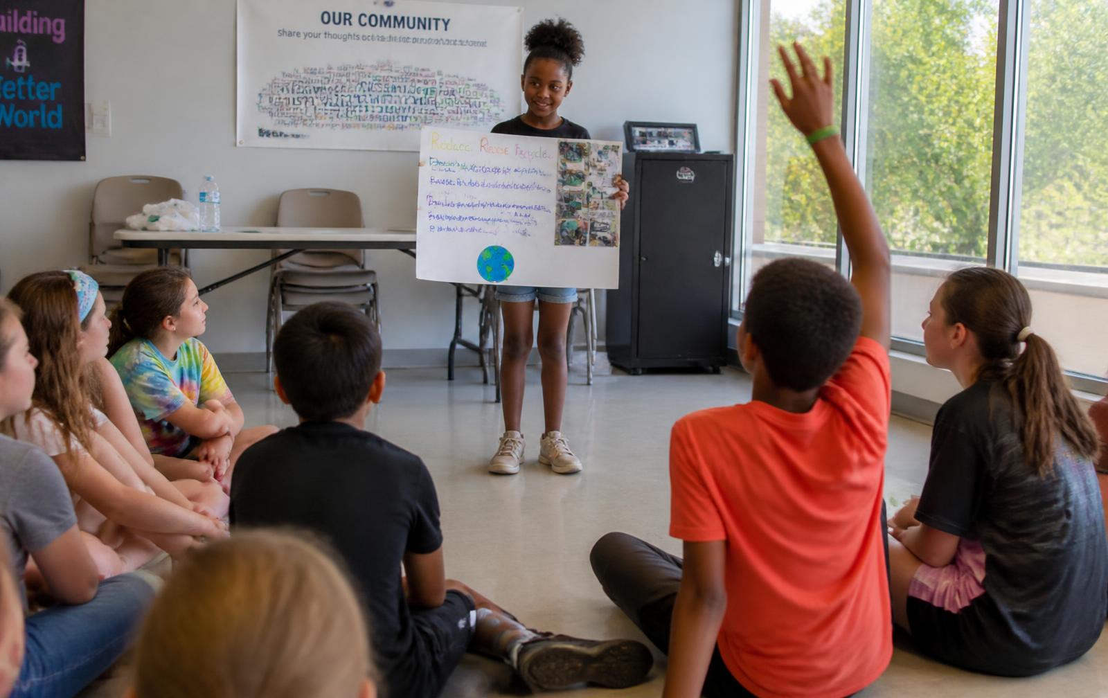 Child presenting a leadership project to parents