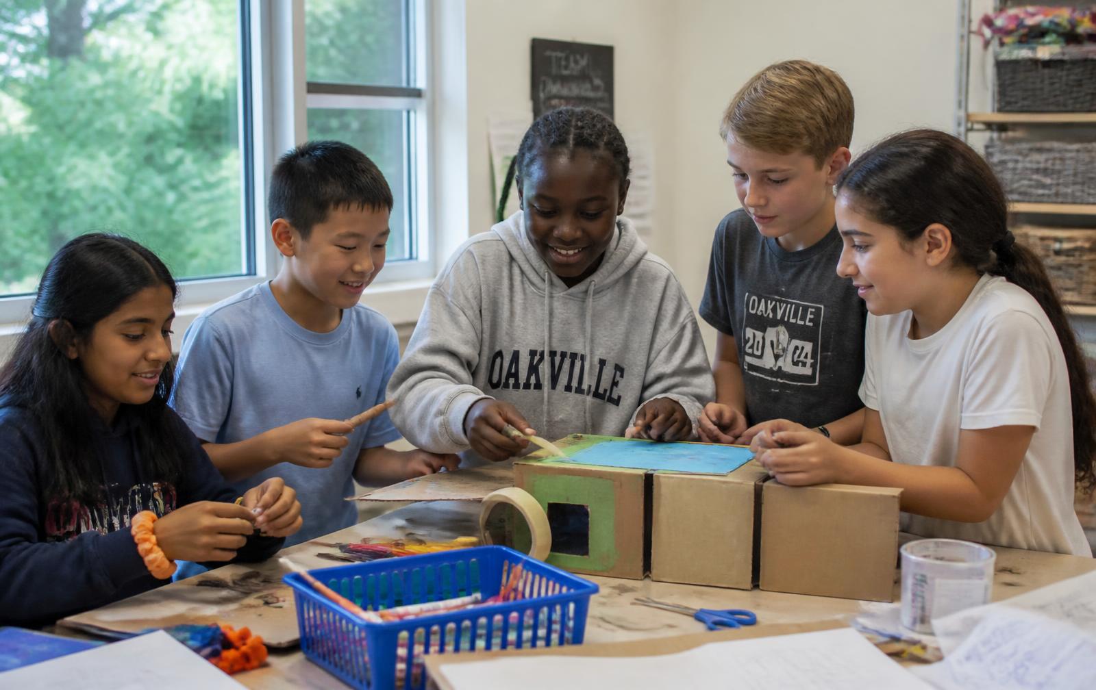 Children working on a robotics project at summer camp